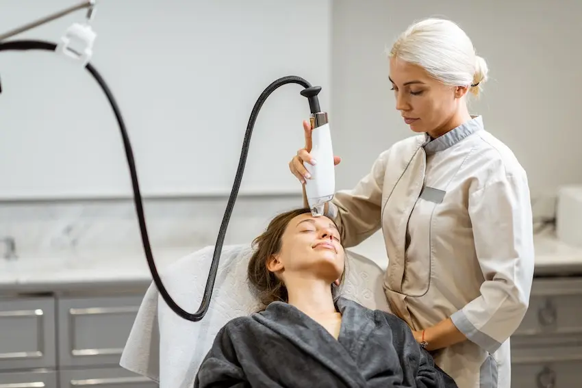 Provider performing a MOXI gentle laser treatment on a patient at Southside Medical & Laser Center.