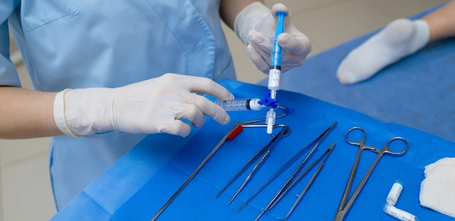 An esthetician is about to perform stretch mark therapy on a patient.